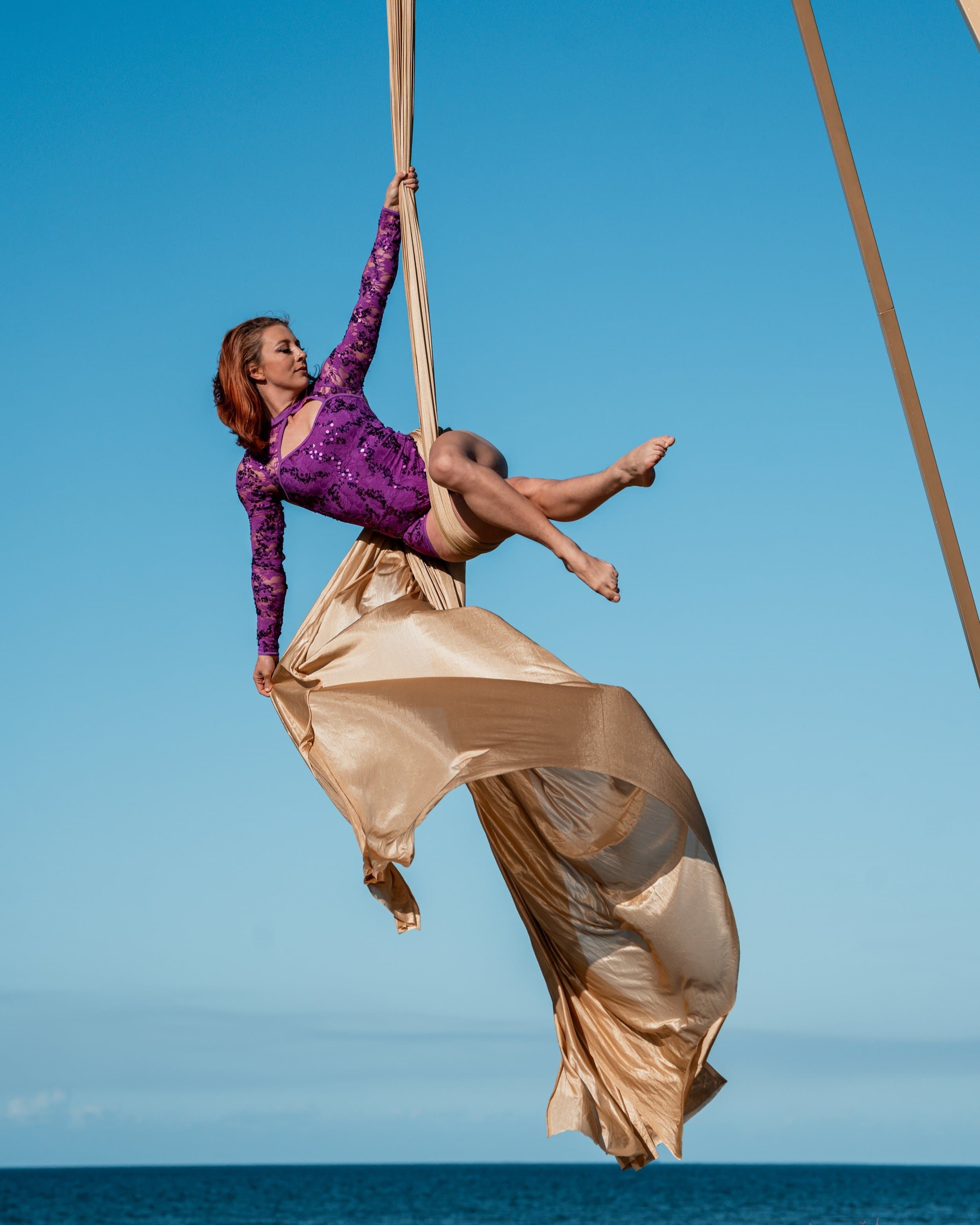 Aerialist performing on silks outdoors
