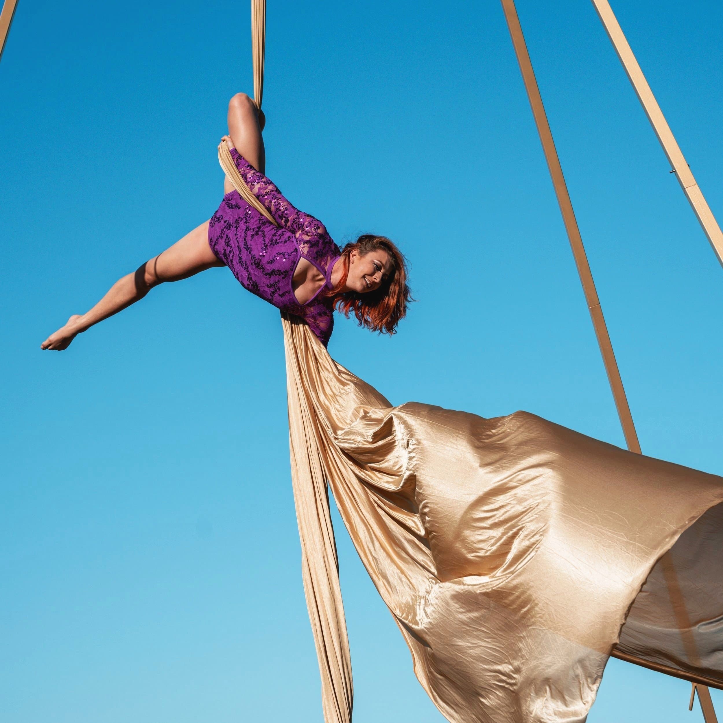 Aerial silks performance against blue sky